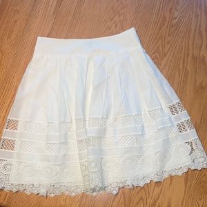 Ann Taylor White lined pleated skirt with eyelet detail on hem.​​​